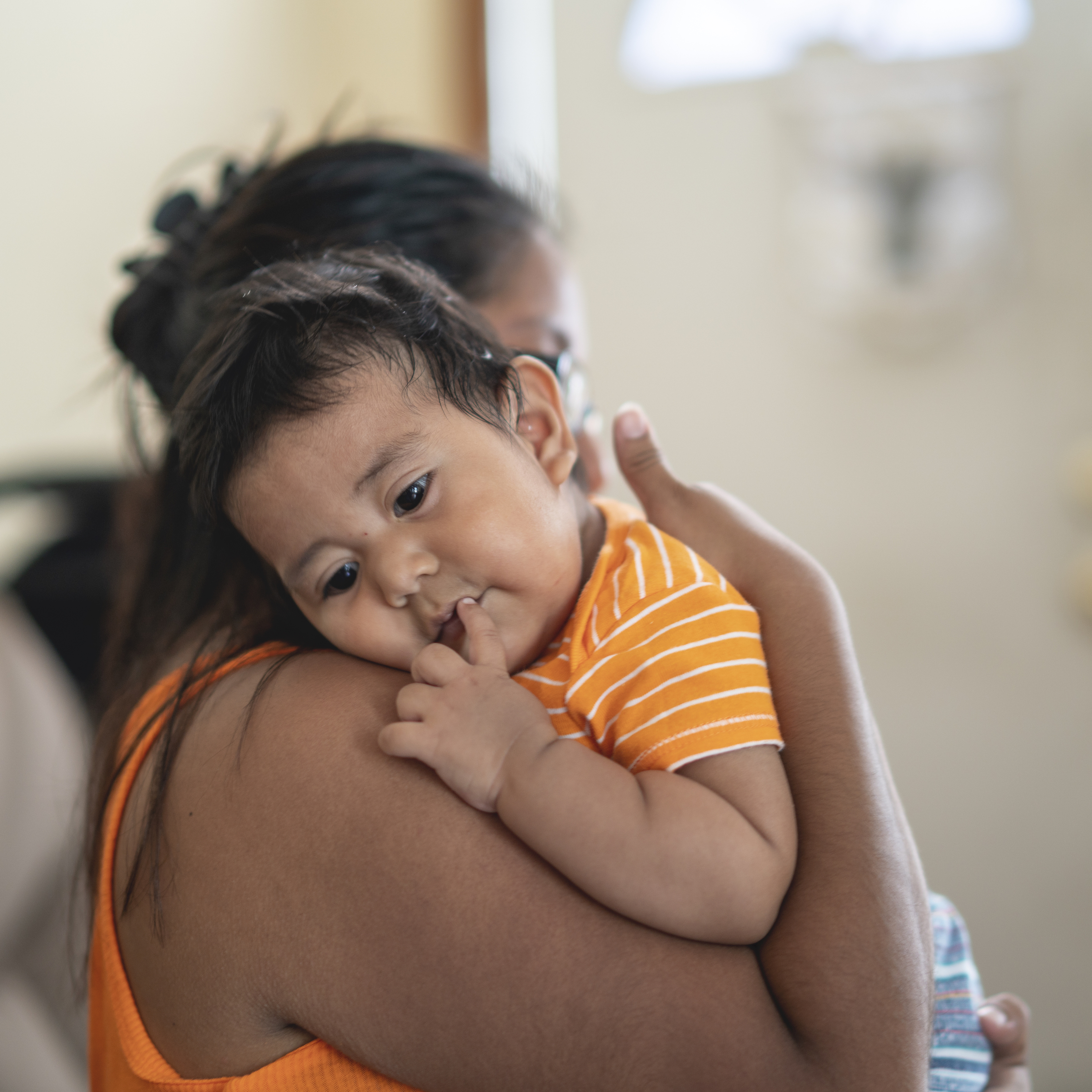 The Latino Mexican-American mother with son, a little boy, in his house in Pennsylvania, USA